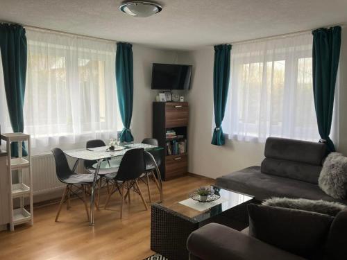 a living room with a table and a couch at Apartmán Karin in Huty