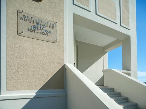 a sign on the side of a building with stairs at Boutique Guesthouse - Marina Monfalcone in Monfalcone