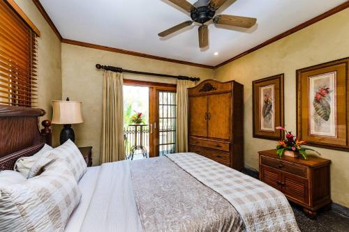 a bedroom with a bed and a ceiling fan at Sunset View Roof Terrace, Steps To The Beach! in Tamarindo