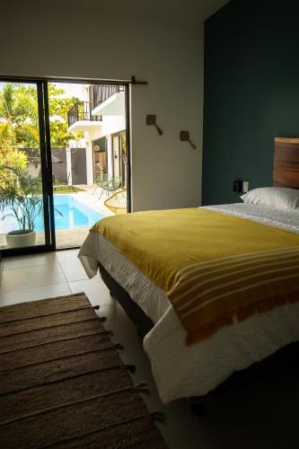 a bedroom with a large bed and a swimming pool at House with private pool, walking distance to beaches & restaurants in Puerto Escondido