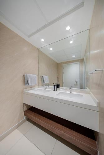 a bathroom with a large sink and a mirror at 2BR Private Apartment in Al Zahia, Sharjah - Stone Haven in Sharjah