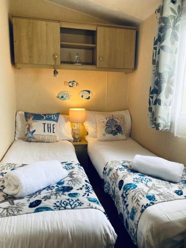 a small room with two beds in it at Calm View in St Austell