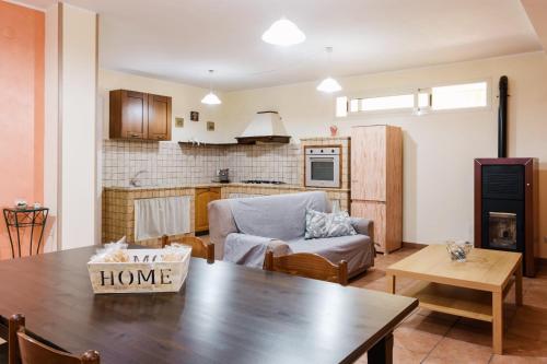 a living room with a table and a kitchen at Dormi'Re in Caserta