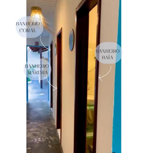 a hallway with signs on the side of a building at Alma Livre - Quartos No Centro de Pipa - in Pipa
