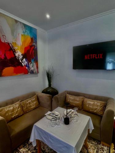 a living room with a couch and a table at Prince Privé Suite in Goranxi