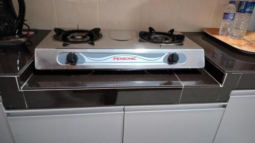 a stove top oven sitting on top of a counter at Liza Homestay in Bachok
