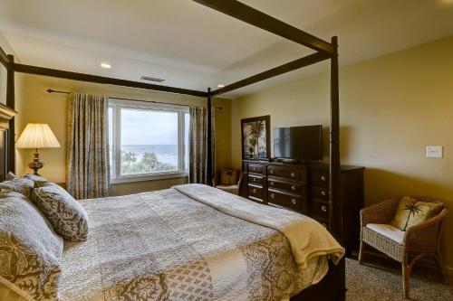 a bedroom with a large bed and a window at SG8C: 8C Seagrove Villa in Isle of Palms