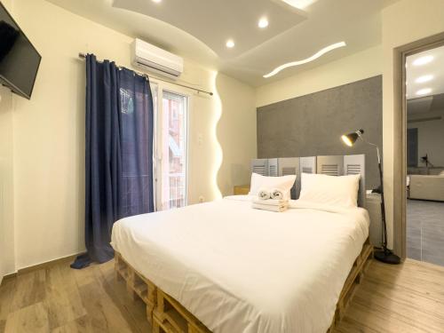 a bedroom with a large bed and a window at Athenian Hideaway - Spa Tub and Walk to Metro in Athens