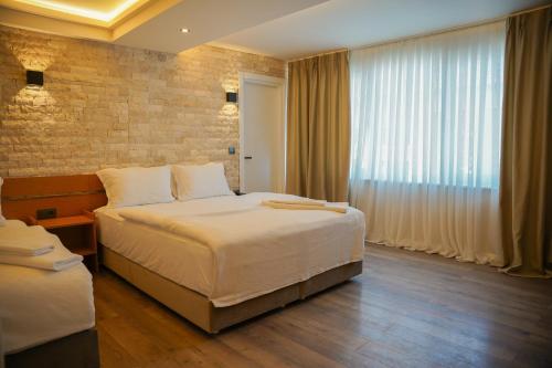 a hotel room with a bed and a window at The MU City Hotel Trabzon in Trabzon