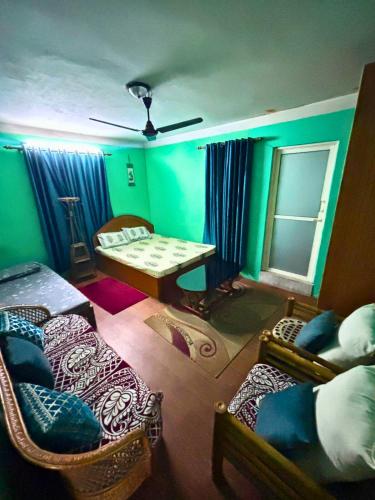 a room with two beds and a table in it at Deepjyoti Inn in Pashupatināth