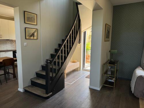 a hallway with a staircase in a home at Maison Eudoise, piscine et spa in Eu