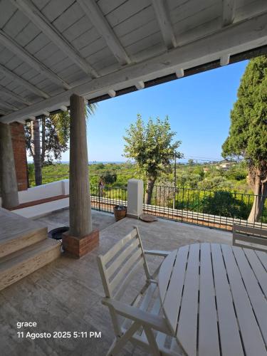 a white chair and a table on a patio at Un'oasi tra i limoni in Naso