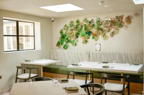a dining room with white tables and chairs at House of George W Davies in Broadway