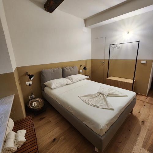 a bedroom with a large bed and a bathroom at Pan da Guardia Poldo in Genova