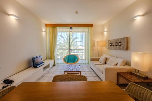 a living room with a couch and a table at The Navigator - Colombus Apartments & Villas in Porto Santo