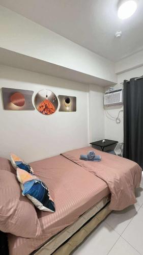 a bedroom with a bed and a air conditioner at Central Near Airport SM Abreeza MDMRC in Davao City