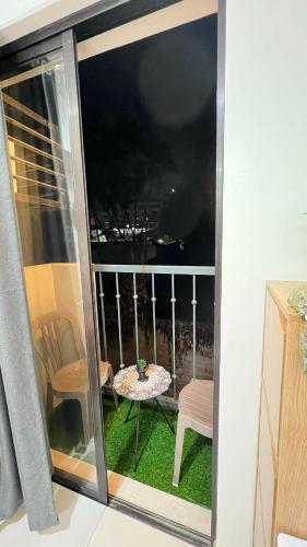 a view of a balcony with a table and a chair at Central Near Airport SM Abreeza MDMRC in Davao City