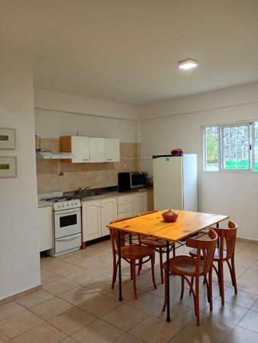 a kitchen with a table and chairs and a refrigerator at Duplex Los Araujos in Yerba Buena