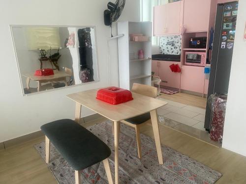 a kitchen with a table with a red object on it at Palmera Residensi in Kajang