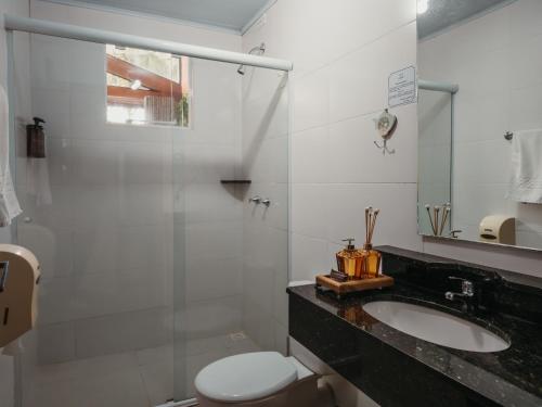 a bathroom with a sink and a toilet at Hotel Sonnet Curitiba in Curitiba