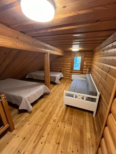 a room with two beds in a log cabin at HonkaRuka, Agrohonka in Ruka