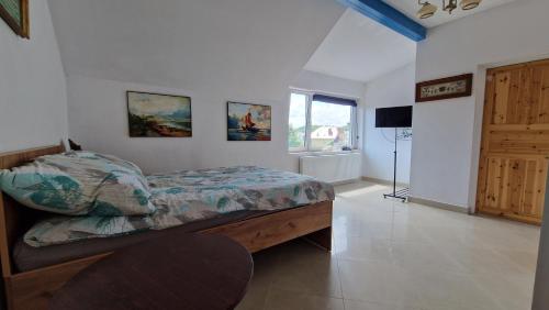 a bedroom with a bed and a television in it at Bos-Znam Pokoje in Gdynia