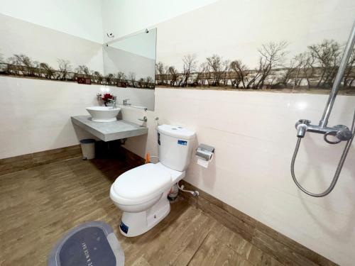 a bathroom with a toilet and a sink at Ella Serene Stay in Ella