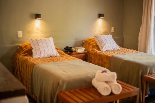a hotel room with two beds with towels on them at DON JUAN posada andina in Tilcara