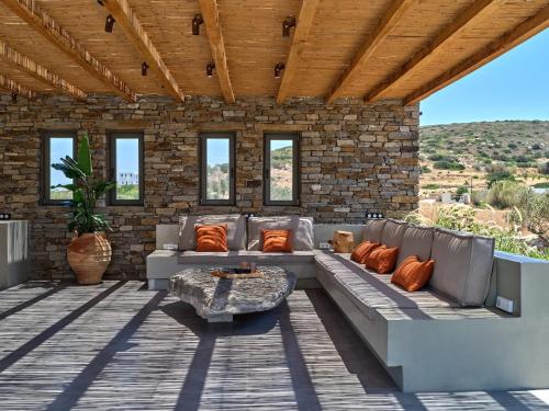 a patio with a couch and a table at Villa Zamira in Isterni