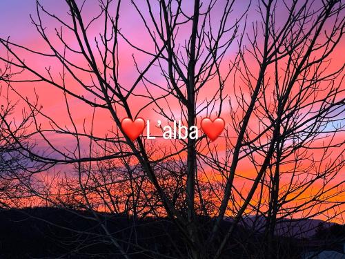 two hearts in a tree with a sunset in the background at Stella Polare B&B in Rieti