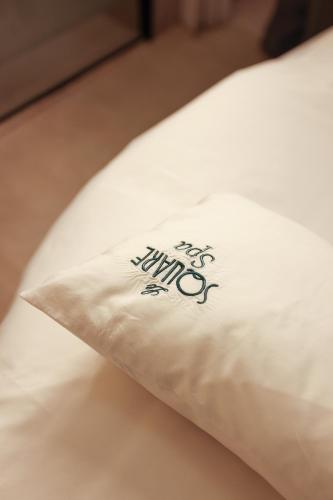 a pillow sitting on top of a bed at Le Square By Onomo Collection in Casablanca