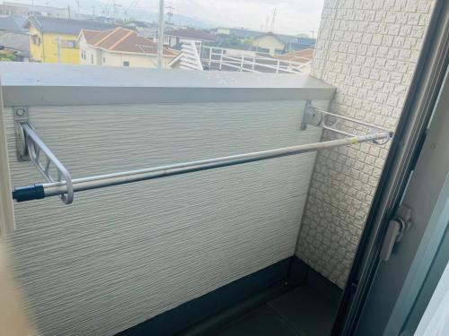 a bathroom door with a towel rail on a balcony at とすアジュール in Tosu