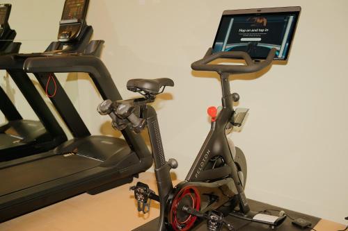 a exercise bike sitting next to a wall with a laptop at Municipal Grand in Savannah