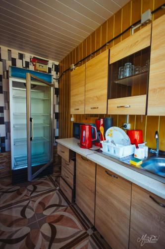 a kitchen with wooden cabinets and a counter top at Casa Dochia in Sfântu Gheorghe