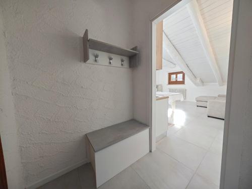 a hallway with a staircase in a house at Hostdomus - Stella Alpina in Pragelato