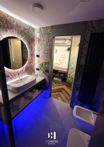 a bathroom with a sink and a mirror at Iris Hotel in Erbusco