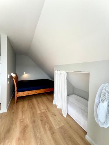 a bedroom with a bed in a attic at Lejnieki Apartment 4 in Pape