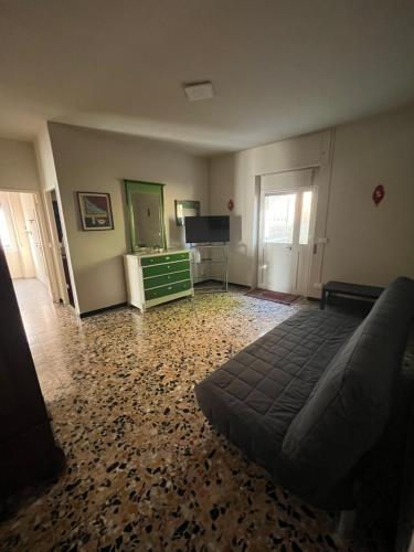 a living room with a bed and a television at Dallo Zio Bruno in Cadepiaggio