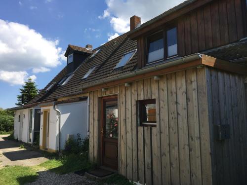 a wooden house with a door on the side of it at Gold Fehmarn in Fehmarn
