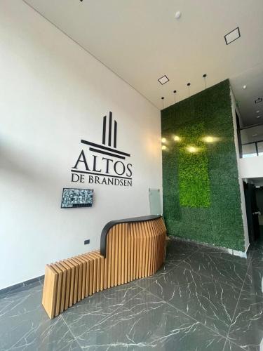 a lobby with a sign on the wall and a bench at Departamento entero en San Lorenzo in San Lorenzo