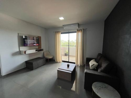 a living room with a couch and a table and a window at Departamento entero en San Lorenzo in San Lorenzo