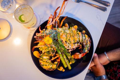 a plate of food with shrimp and vegetables on a table at Secret Harbour Beach Resort in St Thomas