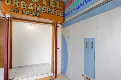 a room with a door and a sign on the wall at Hotel O Dream Space in Ahmedabad
