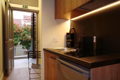 a kitchen with a sink and a counter top at Absolute Athens Acropolis Muses in Athens