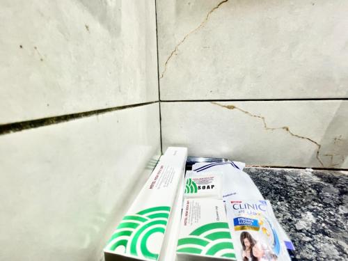 two toothbrushes sitting on a counter next to a wall at SWIMMING POOL HOTEL R - B PREMIUM Puri in Puri