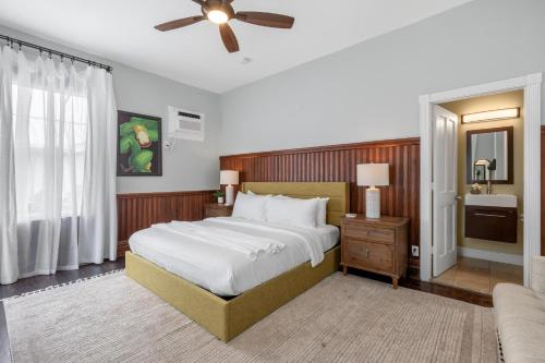 a bedroom with a large bed and a ceiling fan at FUENTE at Azul Mansion Key West in Key West