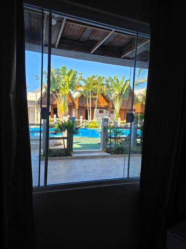 a view of a pool from a window at Pousada Buenos Aires in Pontal do Paraná