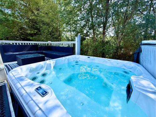 a jacuzzi tub sitting on top of a patio at Lovely Hot Tub Caravan in Northumberland, Free Golf Access, Dog Friendly in Swarland
