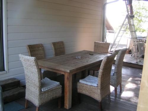 a wooden table and chairs on a porch at Wellness und Wander Oase Burgwald 