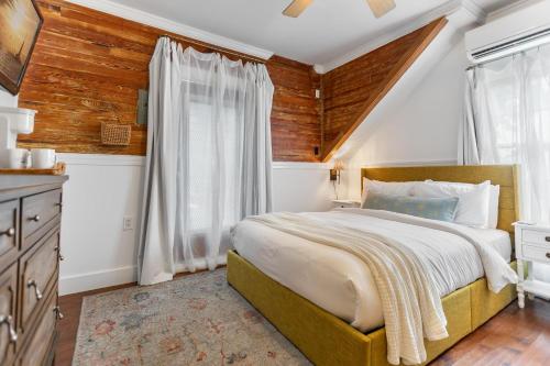 a bedroom with a large bed and a window at THE WHITEHEAD ROOM at Inn on Fleming Key West! in Key West